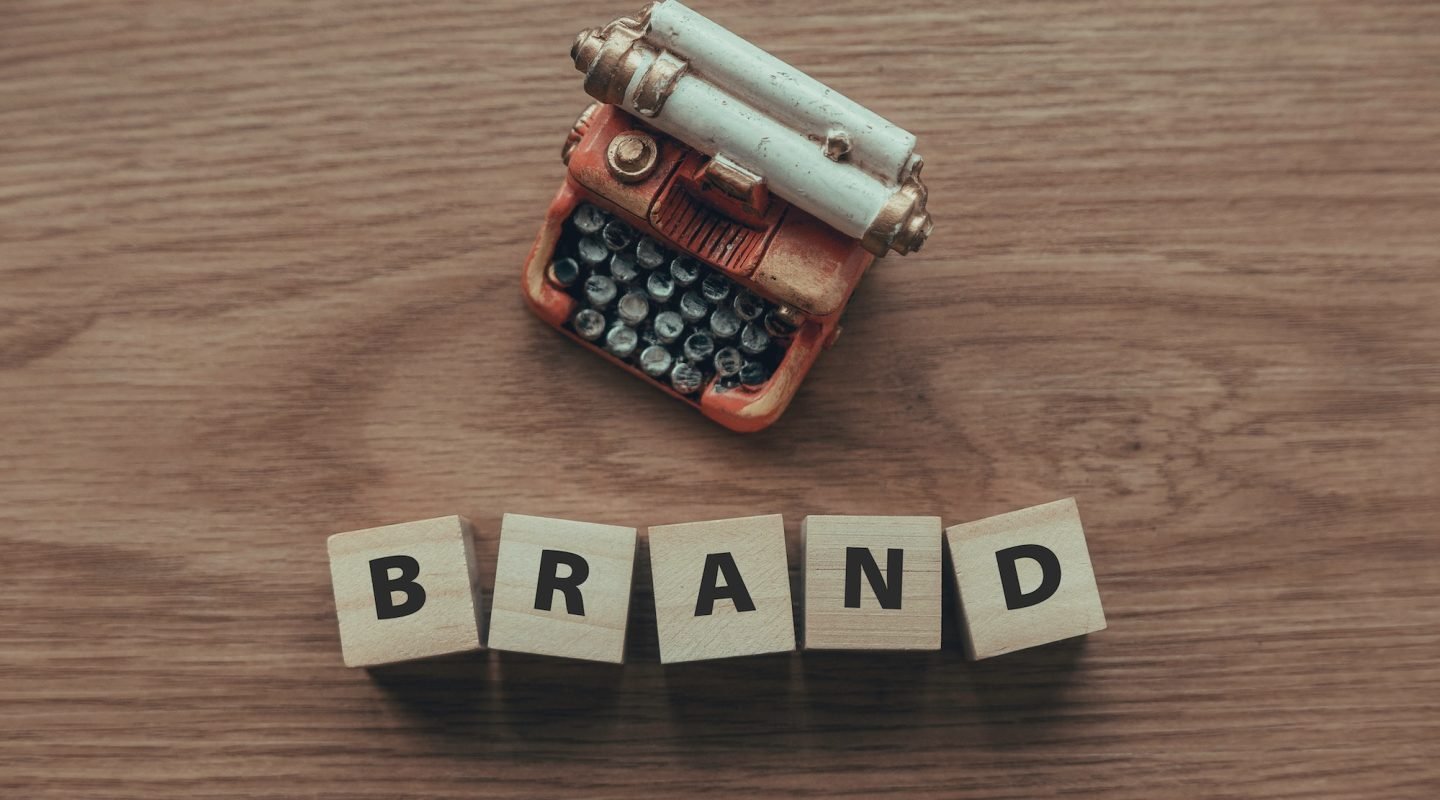 top-view-of-typewriter-and-wooden-cube-with-text-brand-on-wooden-background-.jpg top-view-of-typewriter-and-wooden-cube-with-text-brand-on-wooden-background-.jpg